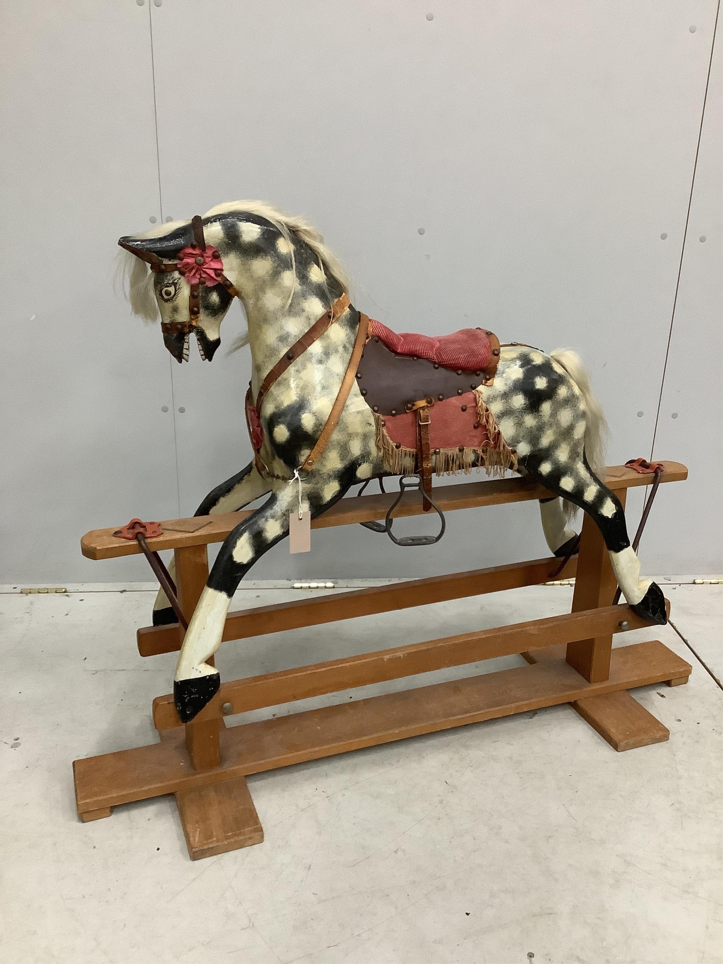 A dapple grey rocking horse, on beech safety frame, length 127cm, height 100cm. Condition - fair